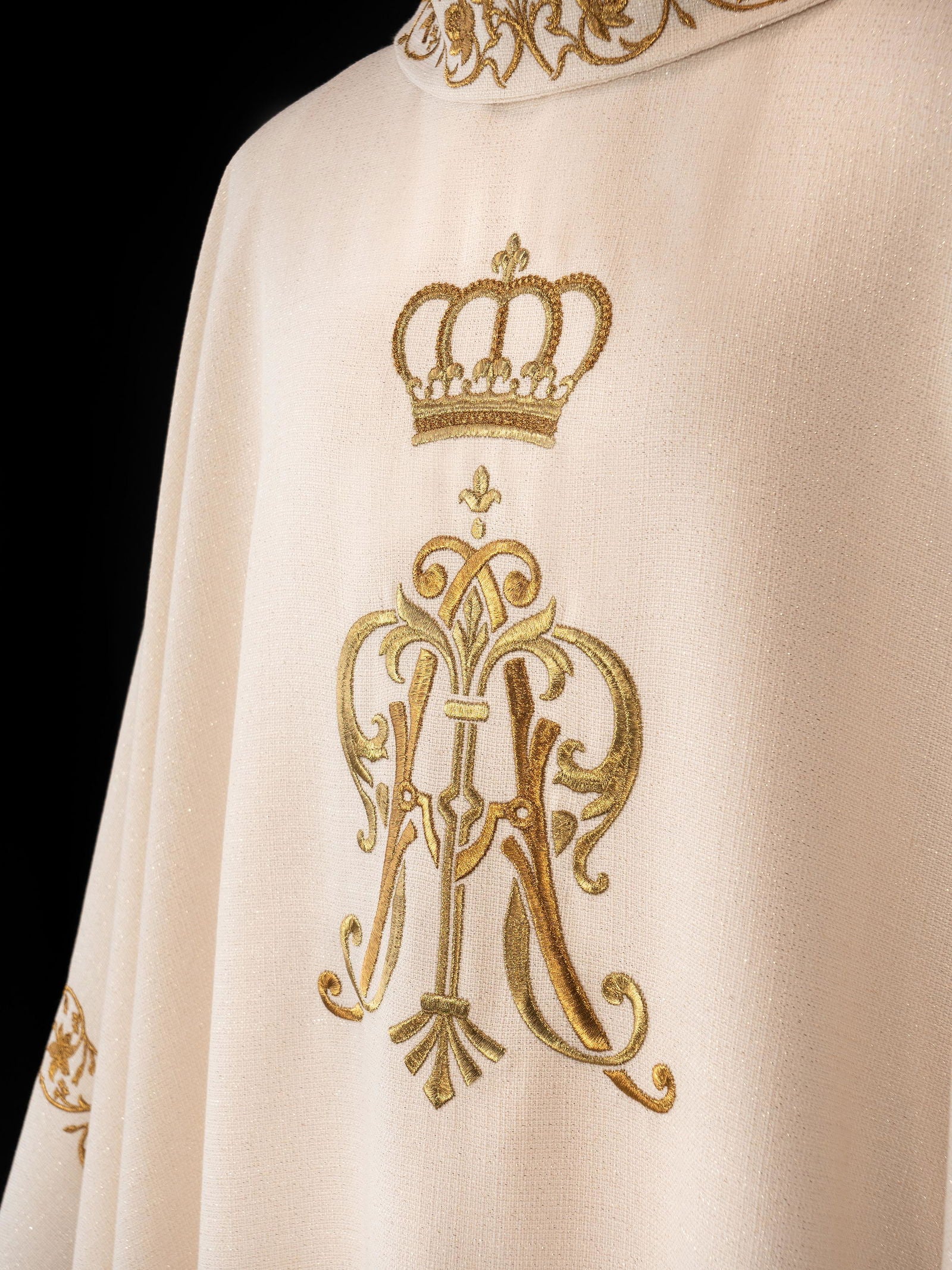 Liturgical chasuble featuring an embroidered Marian emblem and a golden crown