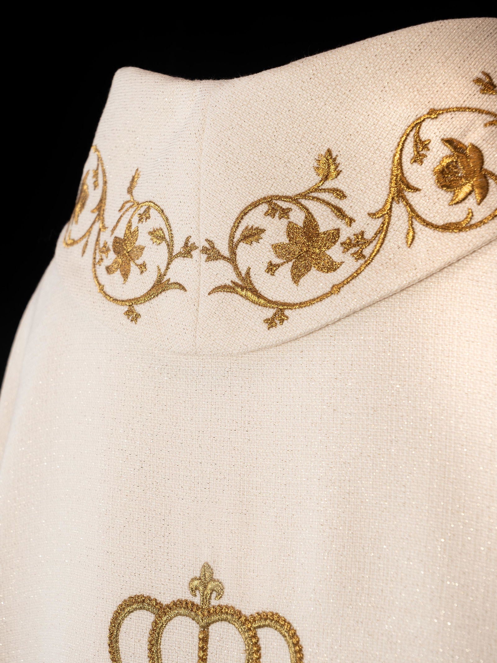 Liturgical chasuble featuring an embroidered Marian emblem and a golden crown